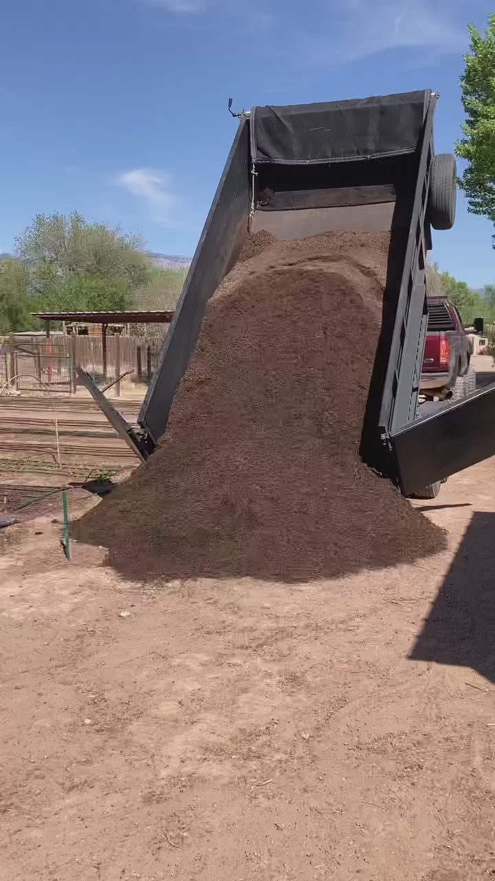 Dump truck delivering compost